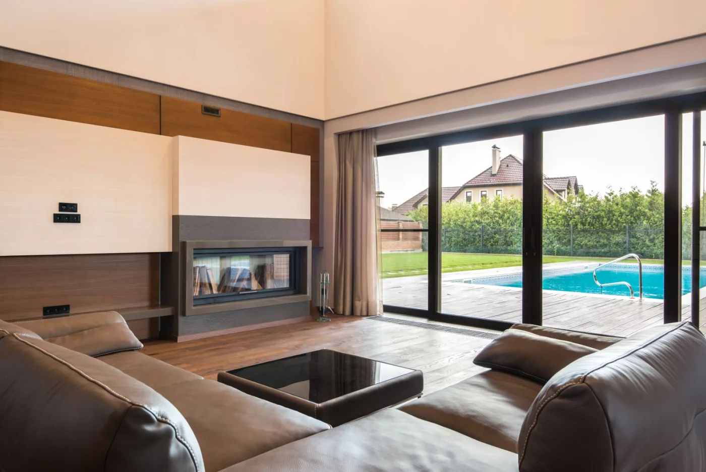 Multi-panel bifold glass door opening a living room onto an outdoor terrace