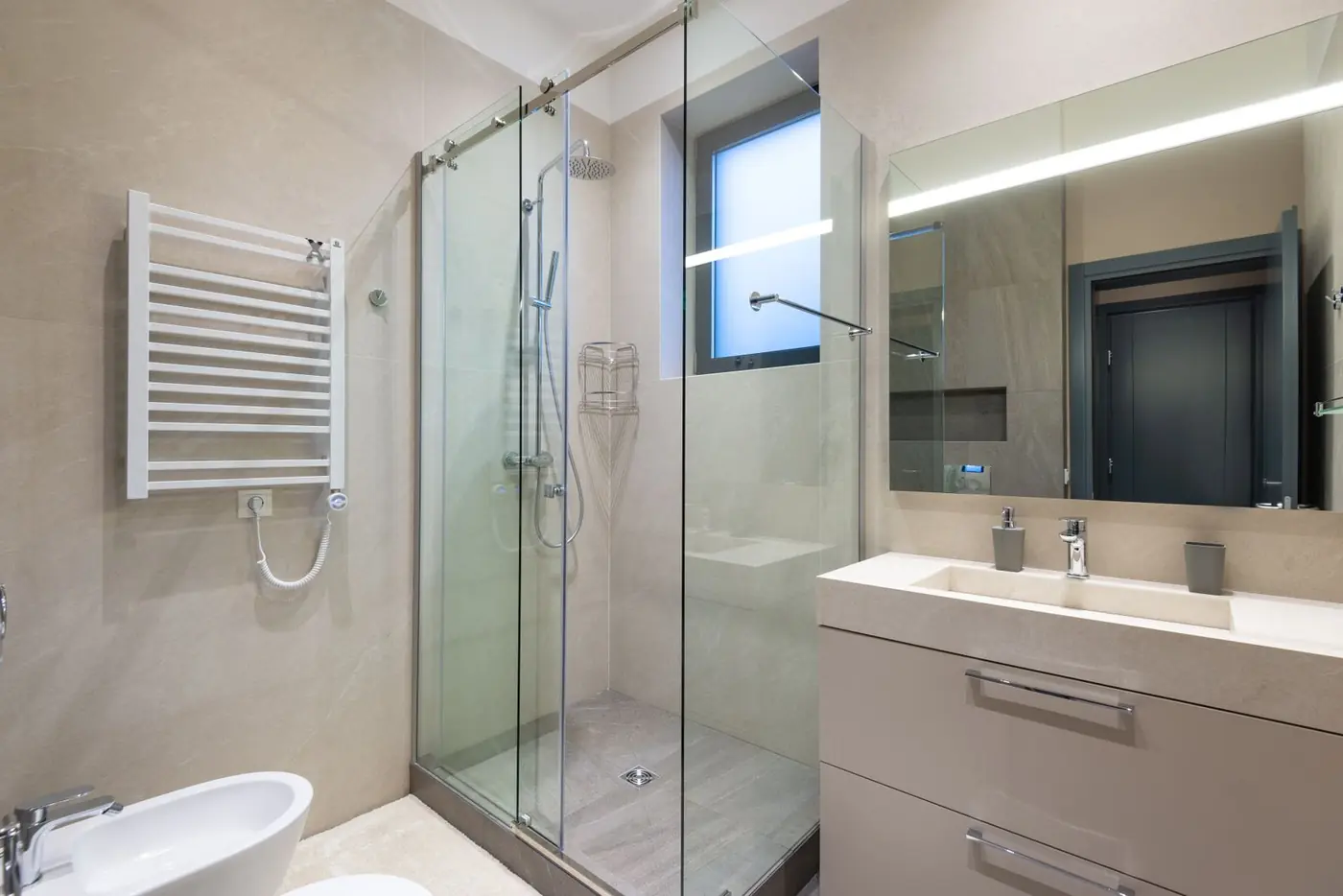Frameless glass shower enclosure