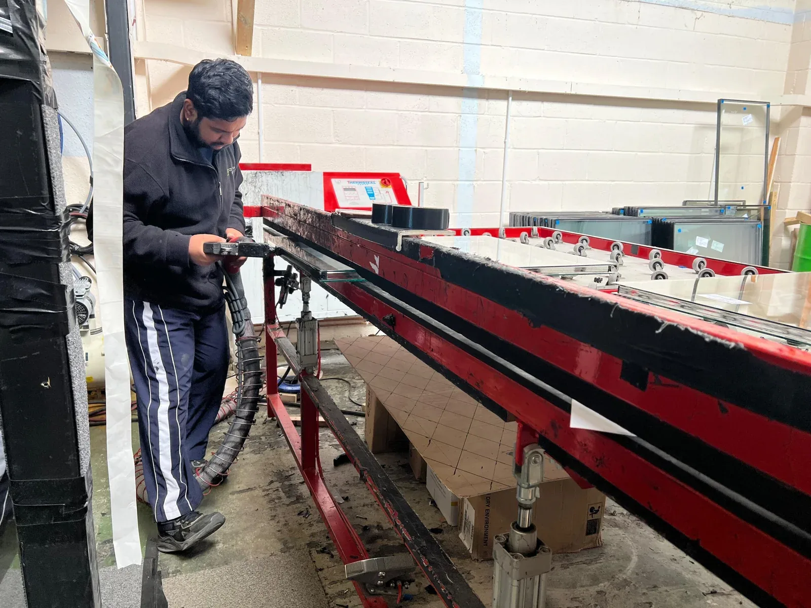 CSU factory technician sealing a glass unit