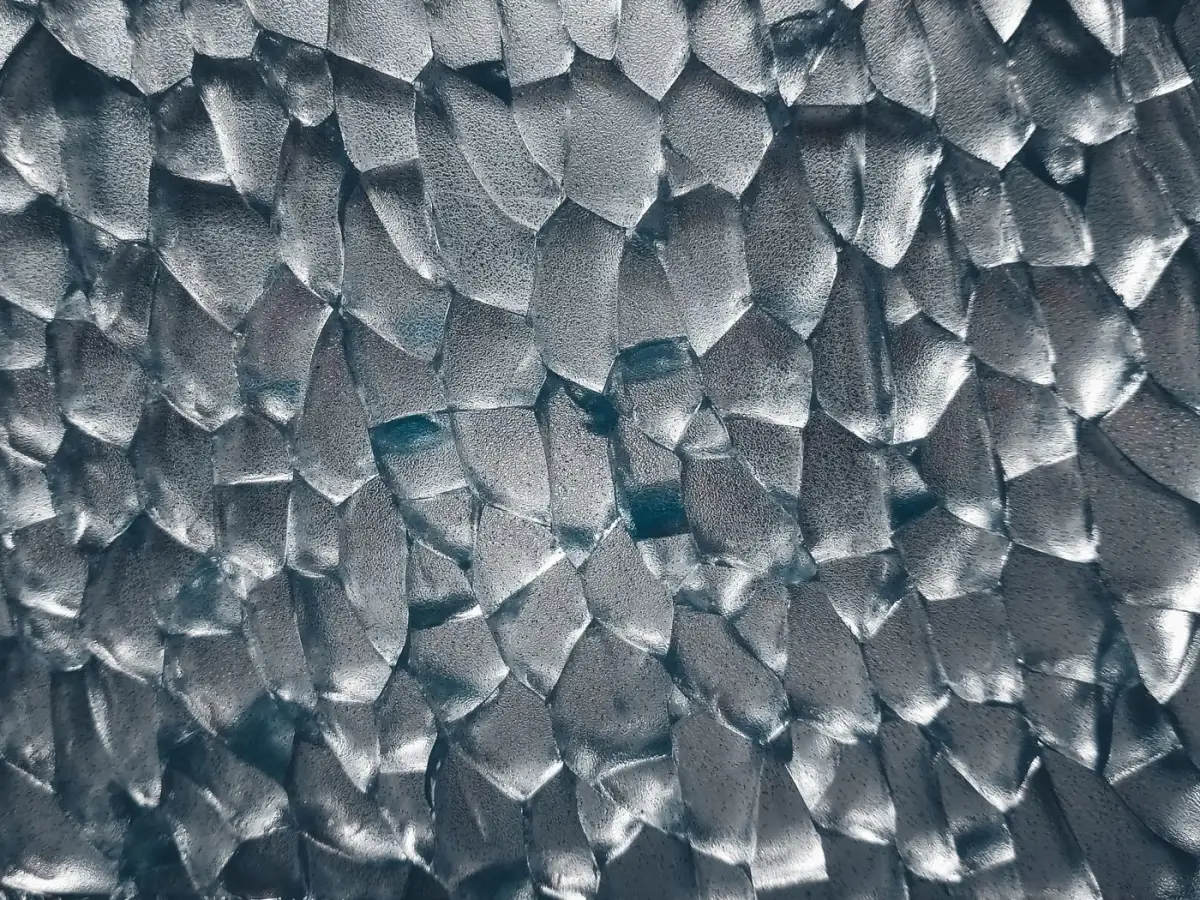 Close-up of hammered textured glass with faceted surface pattern