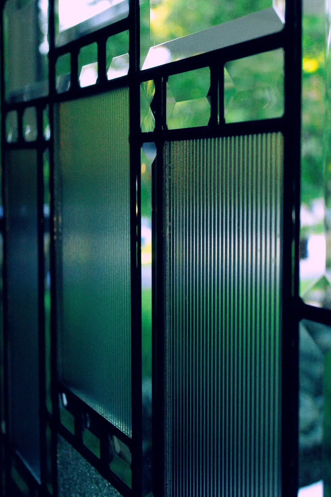 Reeded textured glass panels with vertical flutes in a glazed screen