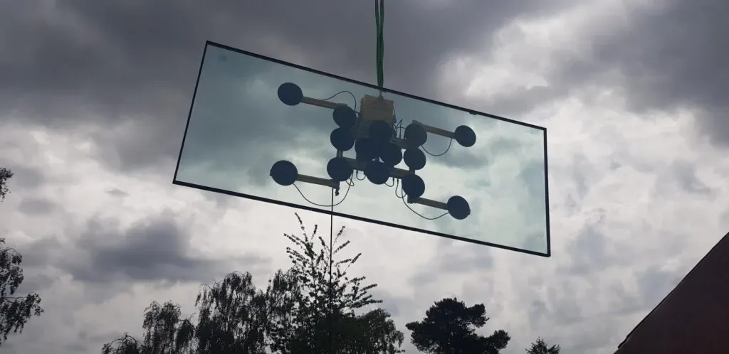 Oversized jumbo glass unit being installed