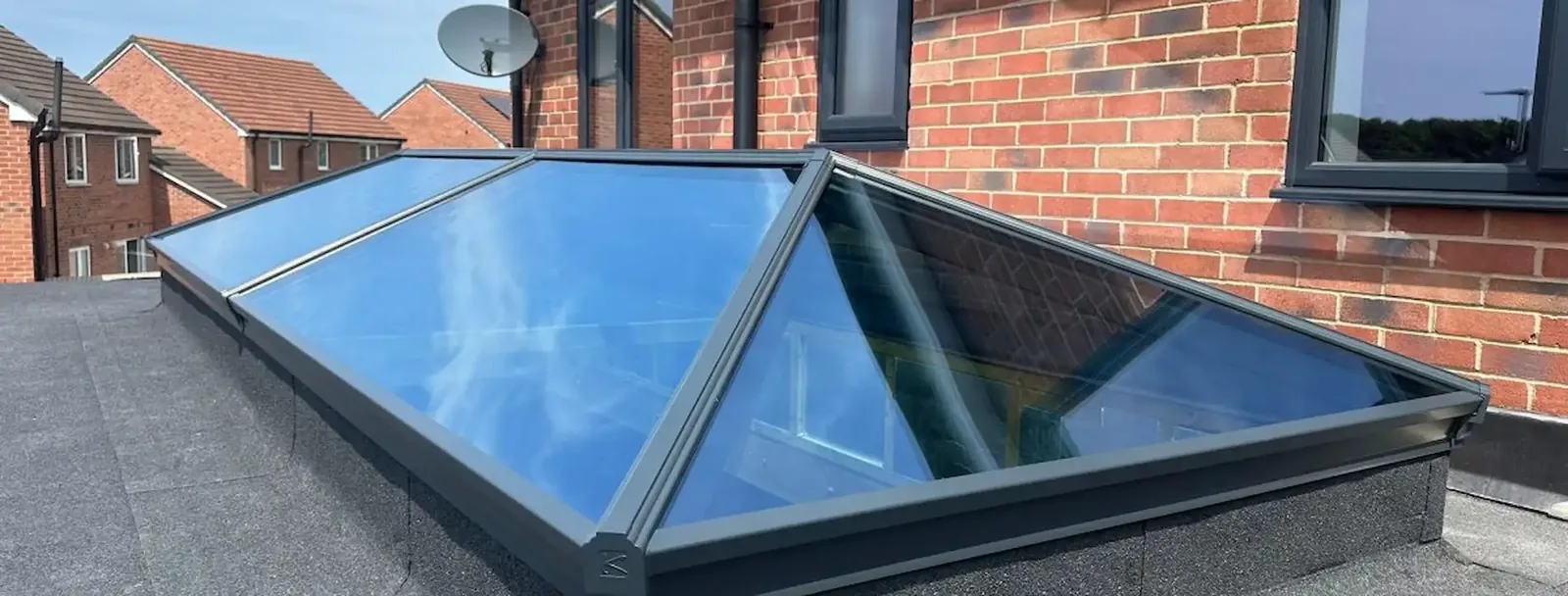 Water sheeting off self-cleaning glass coating